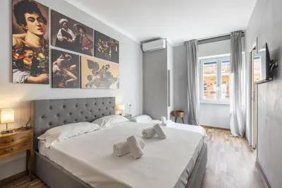 a bedroom with a large bed with two towels on it at Vatican 2bedr apt in Rome