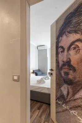 a painting of a man on a wall in a bedroom at Vatican 2bedr apt in Rome