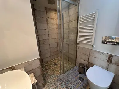 a bathroom with a shower with a toilet and a sink at Greci Suite in Rome