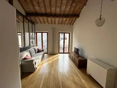 a living room with a couch and a tv at Greci Suite in Rome