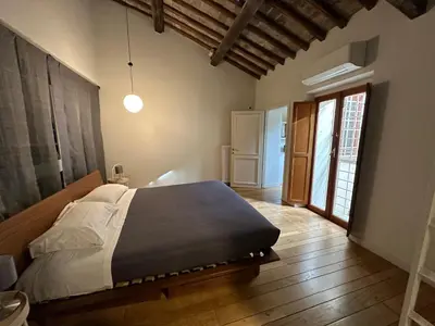 a bedroom with a bed and a large window at Greci Suite in Rome