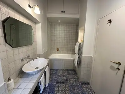 a bathroom with a sink and a tub and a toilet at Greci Suite in Rome