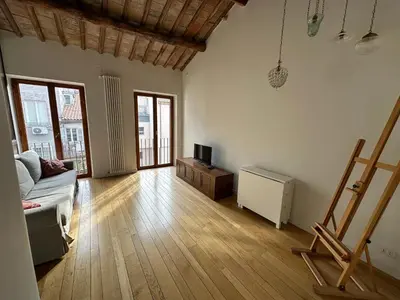 a living room with a couch and a television in it at Greci Suite in Rome