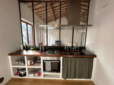 a kitchen with a stove and a counter top at Greci Suite in Rome