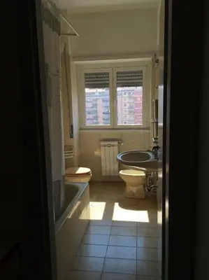 a bathroom with a tub and a toilet and a sink at Casa Marconi apt in Rome