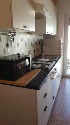 a kitchen with a stove and a microwave on a counter at Casa Marconi apt in Rome