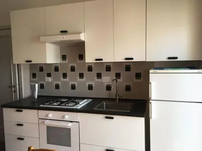 a kitchen with white cabinets and a sink and a stove at Casa Marconi apt in Rome