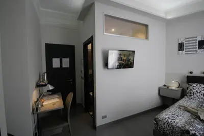 a bedroom with a bed and a table and a desk at Guest House Sinfonia sul Tevere in Rome
