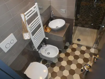 a bathroom with a toilet and a sink and a shower at Guest House Sinfonia sul Tevere in Rome