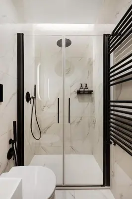 a shower with a glass door in a bathroom at Piave Boutique Guest House in Rome