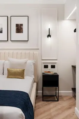a bedroom with a bed and a side table at Piave Boutique Guest House in Rome