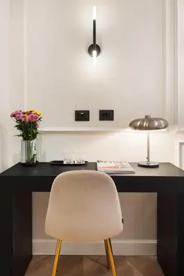 a desk with a chair and a lamp at Piave Boutique Guest House in Rome