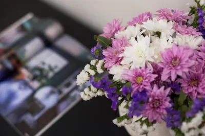 a bouquet of purple and white flowers in a vase at Volturno Boutique Apartment in Rome