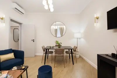 a living room with a table and a blue couch at Volturno Boutique Apartment in Rome
