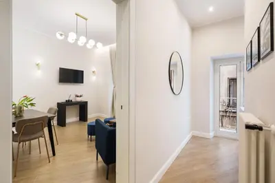 a living room with a table and a dining room at Volturno Boutique Apartment in Rome