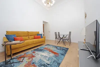 a living room with a yellow couch and a table at Binario 30 in Rome