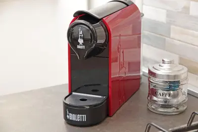 a coffee maker sitting next to a glass jar at Binario 30 in Rome