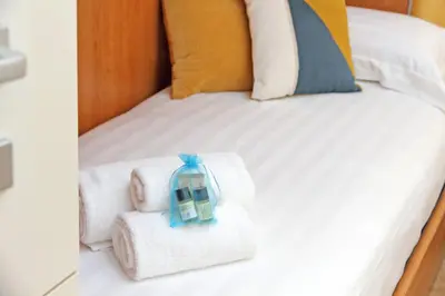 a bed with towels and a toy house on it at Binario 30 in Rome