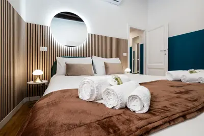 a bedroom with a large bed with towels on it at Domus Maggiore Apartment in Rome