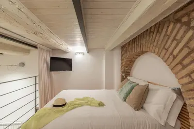 a bedroom with a large white bed with a window at iFlat Cozy & Serene Loft Two Steps from Vatican in Rome