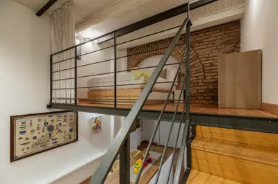 a room with a bunk bed and a staircase at iFlat Cozy & Serene Loft Two Steps from Vatican in Rome