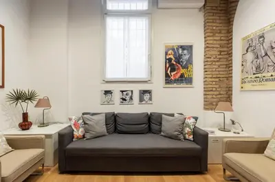 a living room with a couch and two tables at iFlat Cozy & Serene Loft Two Steps from Vatican in Rome