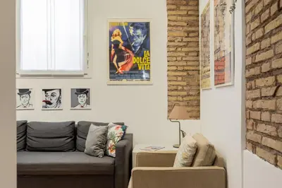 a living room with a couch and posters on the wall at iFlat Cozy & Serene Loft Two Steps from Vatican in Rome
