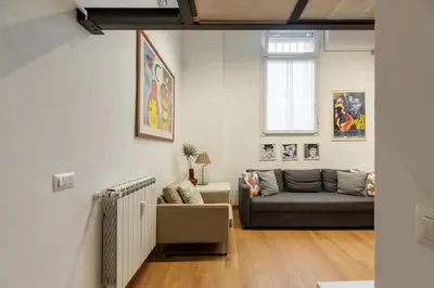 a living room with a couch and a window at iFlat Cozy & Serene Loft Two Steps from Vatican in Rome