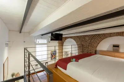 a bedroom with a bed and a balcony at iFlat Cozy & Serene Loft Two Steps from Vatican in Rome