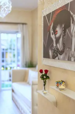 a living room with a picture of a woman at San Pietro Panoramic View in Rome