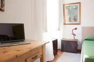 a laptop computer sitting on a wooden desk in a room at Shangrila in Rome