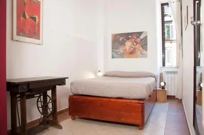 a bedroom with a bed and a desk in it at Shangrila in Rome