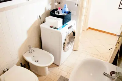 a bathroom with a washing machine and a sink at Shangrila in Rome