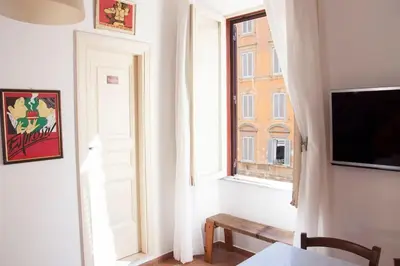 a room with a window and a table and a tv at Shangrila in Rome