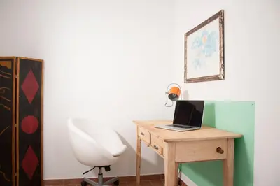 a room with a desk with a laptop and a chair at Shangrila in Rome