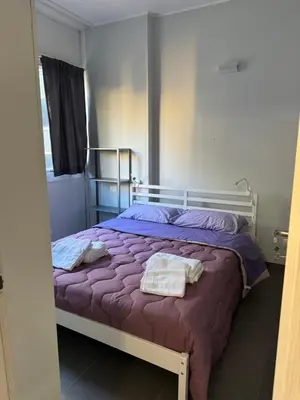 a bedroom with a bed with purple sheets and a mirror at Al 304 a San Giovanni in Rome
