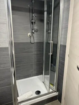 a shower with a glass door in a bathroom at Al 304 a San Giovanni in Rome