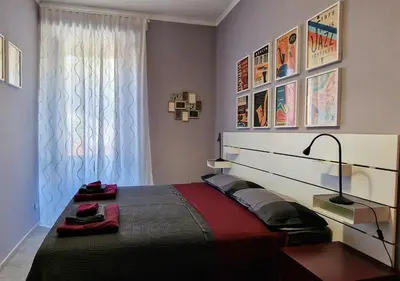 a bedroom with a large bed and a window at Appartamento JazzNBlues House in Rome