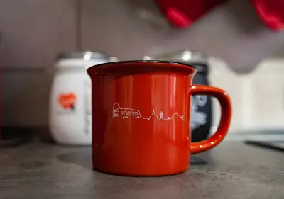 an orange coffee cup sitting on a table at Appartamento JazzNBlues House in Rome