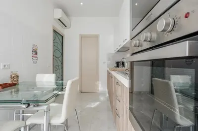 a kitchen with a glass table and a stove at Maison Riboty - by 101Flats in Rome