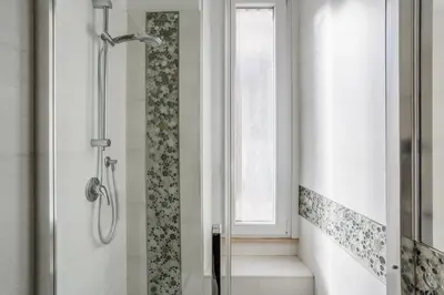 a shower stall in a bathroom with a window at Maison Riboty - by 101Flats in Rome