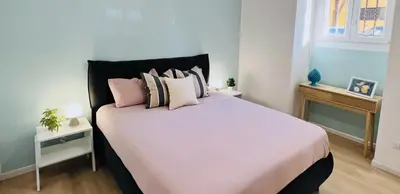 a bedroom with a large white bed with pillows at Flowflat Vatican in Rome