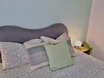 a bed with a bunch of pillows on it at Flowflat Vatican in Rome