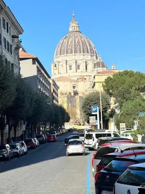 a street with cars parked on the side of a building at Flowflat Vatican in Rome