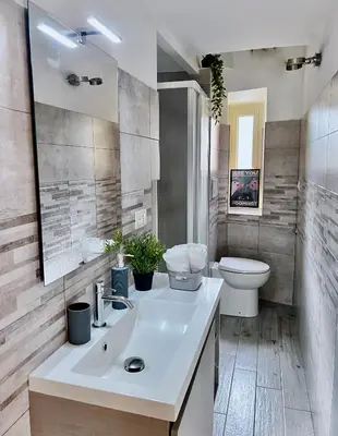 a bathroom with a white sink and a toilet at FlowflatPigneto in Rome