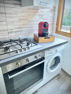 a kitchen with a stove and a washing machine at FlowflatPigneto in Rome