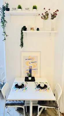 a white dining room table with chairs and plants at FlowflatPigneto in Rome