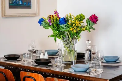 a table with a vase of flowers on it at Vatican Blossom in Rome