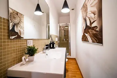 a bathroom with a white sink and a mirror at Vatican Blossom in Rome