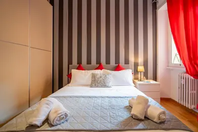 a bedroom with a bed with towels on it at Vatican Blossom in Rome